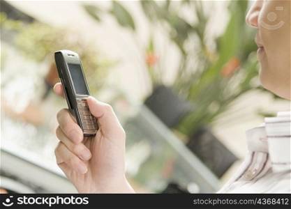 Close-up of a male office worker operating a mobile phone