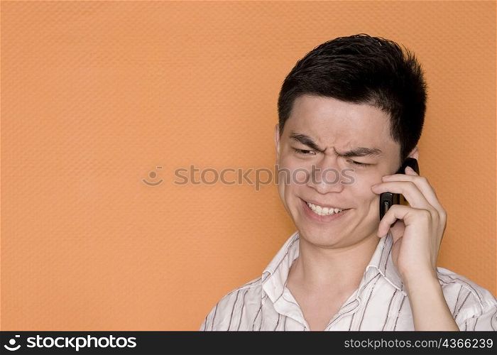 Close-up of a male office worker talking on a mobile phone