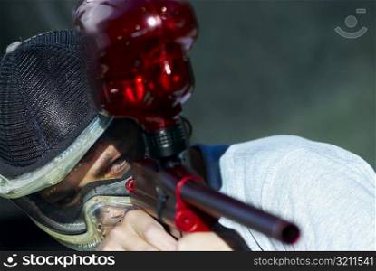 Close-up of a man aiming with a paintball gun