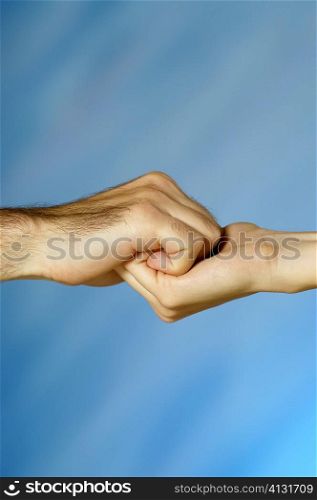 Close-up of a man and a woman holding hands