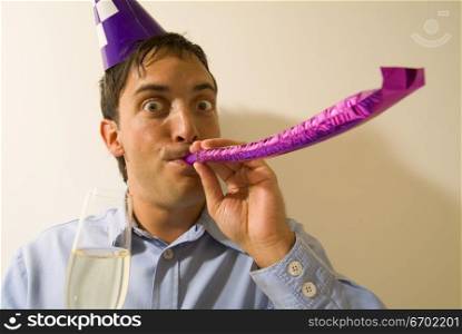 Close-up of a man blowing a party favor