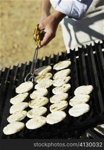 Close-up of a man cooking on a barbeque grill