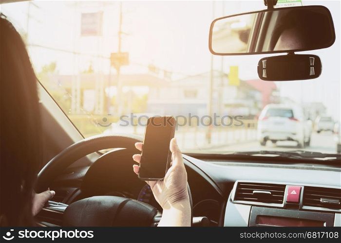 Close up of a man driving car dangerously while using mobile phone