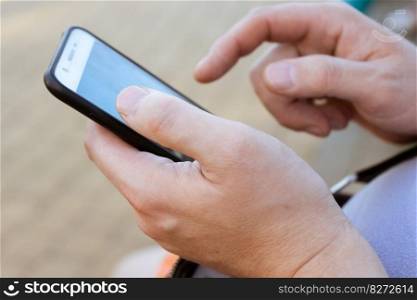 Close up of a man hands using mobile, scroll smart phone screen. Man hands scroll screen mobile smart phone