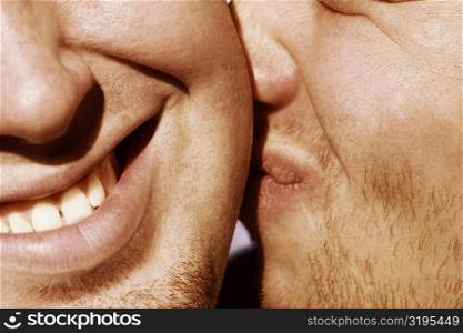 Close-up of a man kissing another man
