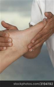 Close-up of a man massaging a person&acute;s foot