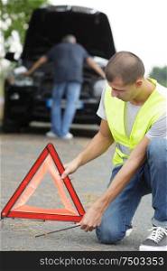 close up of a man putting road triangle