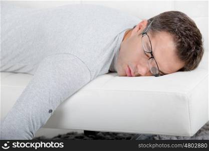 close up of a man sleeping on sofa