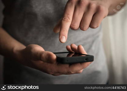 Close up of a man using mobile smart phone