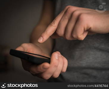 Close up of a man using mobile smart phone