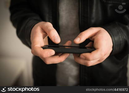 Close up of a man using mobile smart phone