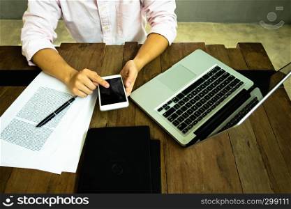 Close up of a man using mobile smart phone on the table