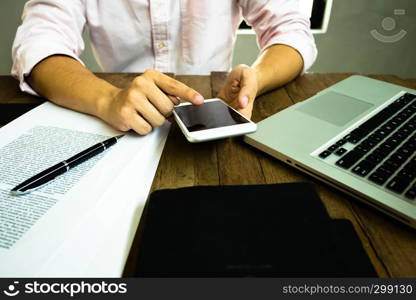 Close up of a man using mobile smart phone on the table