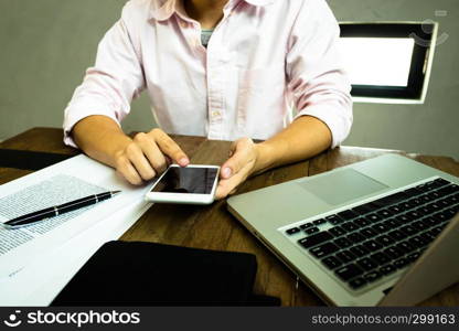 Close up of a man using mobile smart phone on the table