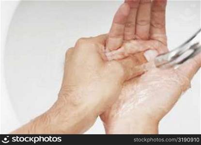 Close-up of a man washing his hands