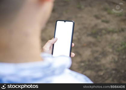 Close up of a man with cell phone in hand, close up shot of a person checking his cell phone, young guy with cell phone in hand with copy space