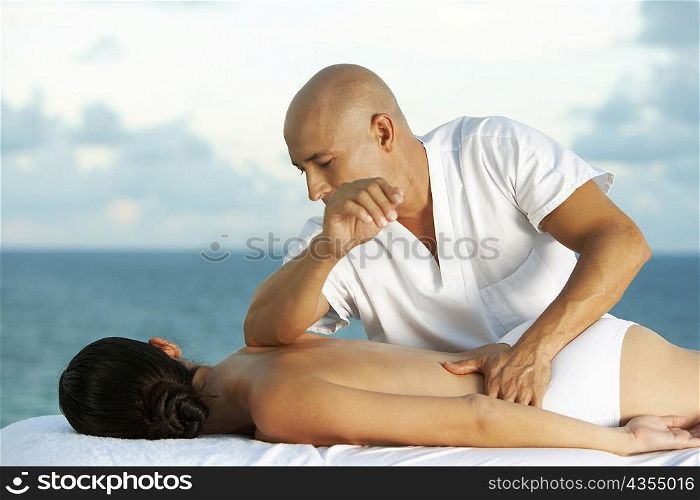 Close-up of a massage therapist massaging a young woman