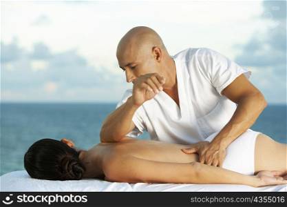 Close-up of a massage therapist massaging a young woman