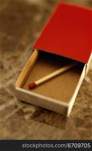 Close-up of a matchstick in a matchbox