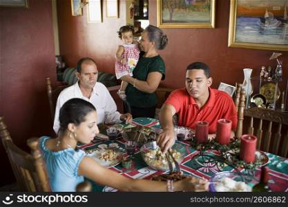Close-up of a mature couple and their children at the dining table