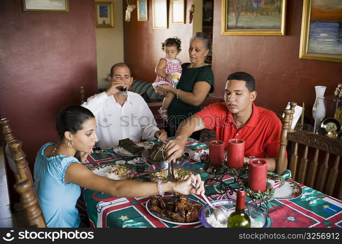 Close-up of a mature couple and their children at the dining table