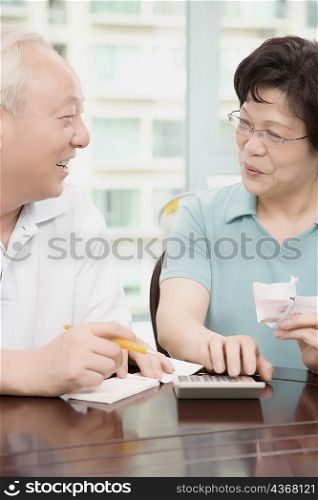Close-up of a mature couple calculating bills