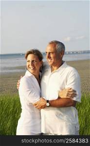 Close-up of a mature couple embracing on the beach