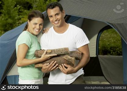 Close-up of a mature couple holding firewood