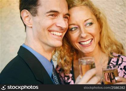 Close-up of a mature couple holding glasses of champagne and smiling