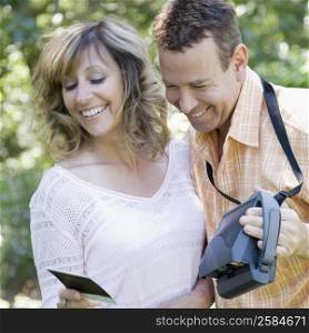 Close-up of a mature couple looking at a photograph and smiling