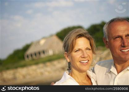 Close-up of a mature couple looking away and smiling