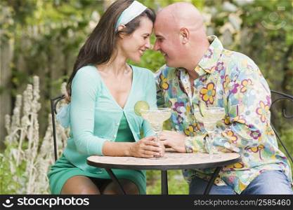 Close-up of a mature couple sitting at a table and smiling