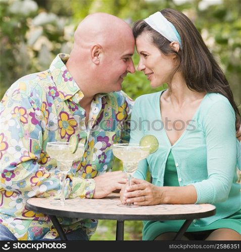 Close-up of a mature couple sitting at a table and smiling