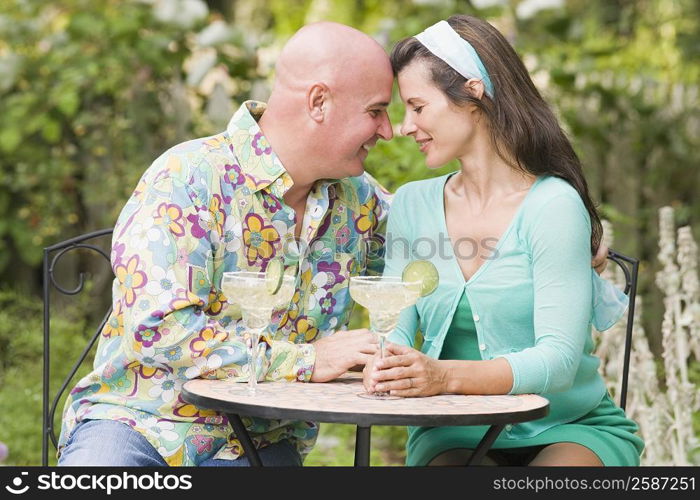 Close-up of a mature couple sitting at a table and smiling