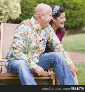 Close-up of a mature couple sitting on a lounge chair and smiling