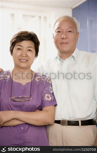 Close-up of a mature couple standing and smiling