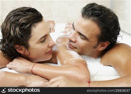 Close-up of a mature couple taking bath in a bathtub