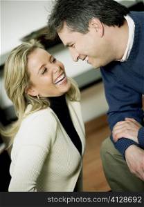 Close-up of a mature man and a mid adult woman looking at each other and smiling