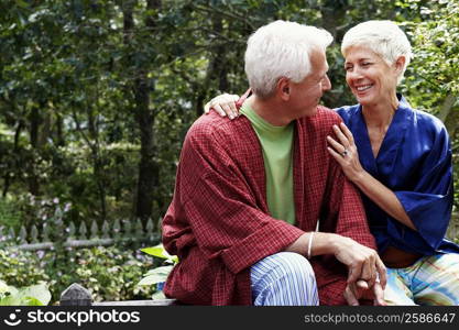 Close-up of a mature man and a senior woman looking at each other and smiling