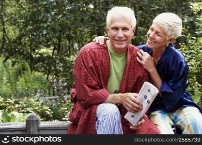 Close-up of a mature man and a senior woman sitting together and smiling