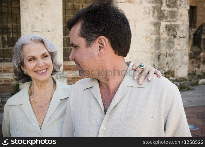 Close-up of a mature man and his mother smiling and looking at each other, Santo Domingo, Dominican Republic