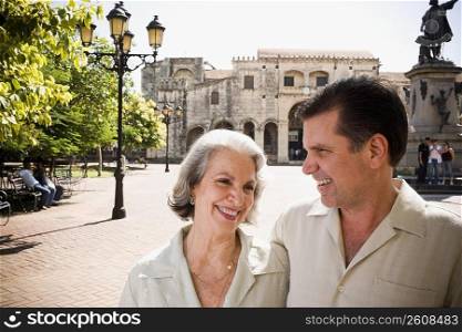 Close-up of a mature man and his mother smiling with a statue in the background, Santo Domingo, Dominican Republic