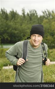 Close-up of a mature man carrying a backpack