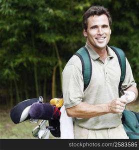 Close-up of a mature man carrying a golf bag