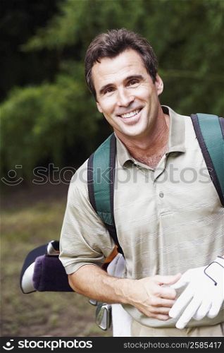 Close-up of a mature man carrying a golf bag