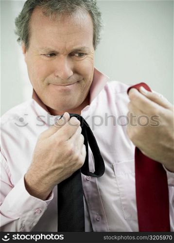 Close-up of a mature man choosing a tie