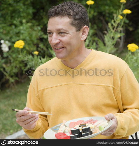 Close-up of a mature man eating sushi