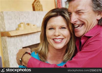 Close-up of a mature man embracing a mature woman and smiling