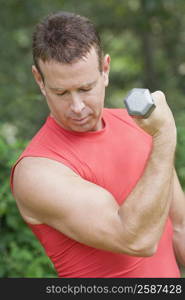 Close-up of a mature man exercising with a dumbbell