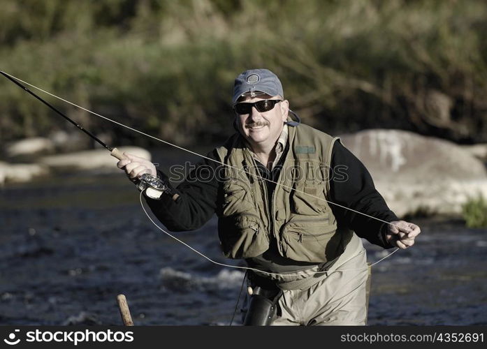 Close-up of a mature man fishing in the river